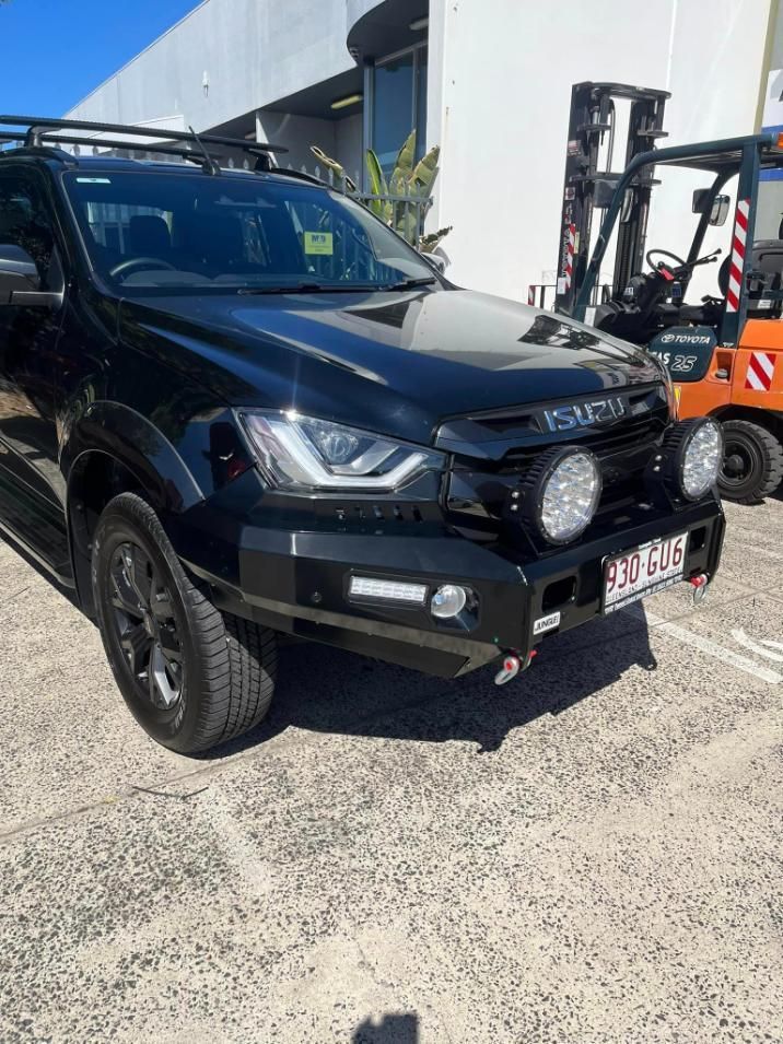 Black Isuzu D-max With Bull Bar and Spotlights, Parked in Front of a Building — Motor Accessories Direct In Robina, QLD