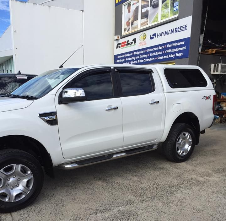 White Pickup Truck With a Canopy Parked Near a Building With Signage — Motor Accessories Direct In Byron Bay, QLD