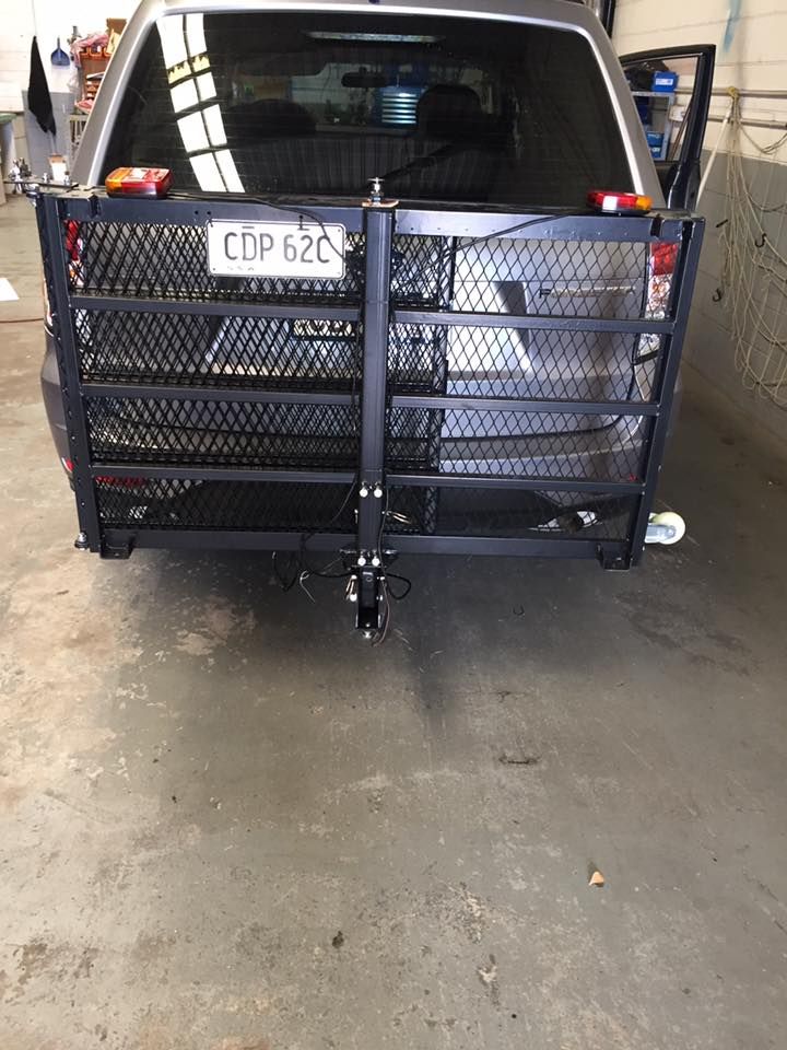 SUV With a Black Metal Wheelchair Carrier Attached to the Rear Bumper — Motor Accessories Direct In Southport, QLD