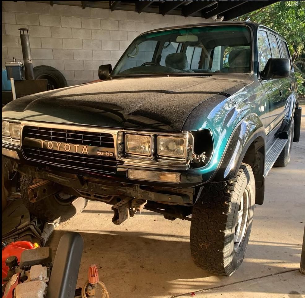 Green Toyota Land Cruiser With Front-end Damage in a Garage — Motor Accessories Direct In Burleigh Heads, QLD