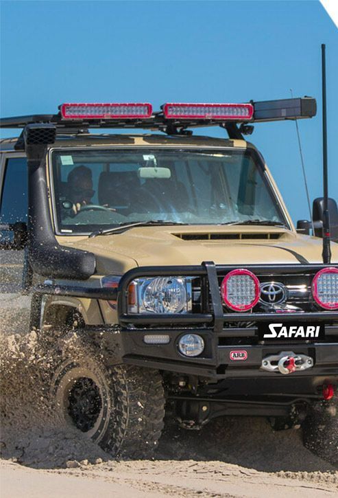 A Safari Truck Is Driving Through the Mud on A Dirt Road — Motor Accessories Direct In Tweed Heads South, NSW