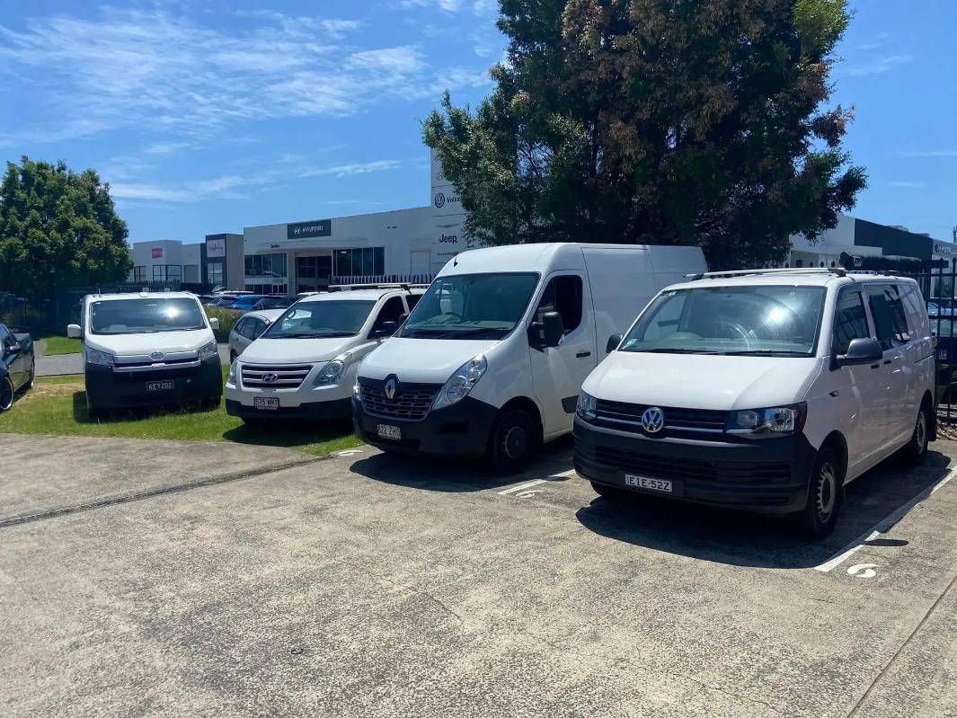 White Vans Parked in a Lot on a Sunny Day — Motor Accessories Direct In Burleigh Heads, QLD