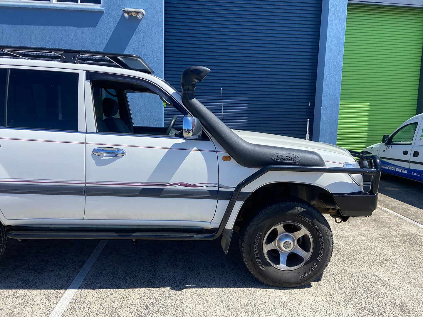 A White Suv with A Snorkel Is Parked in Front of A Building — Motor Accessories Direct In Tweed Heads South, NSW