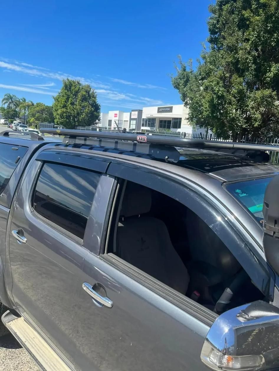 Gray Truck With Roof Rack and Side Window Visors Under a Blue Sky — Motor Accessories Direct In Burleigh Heads, QLD