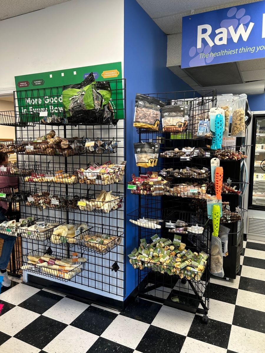 A store filled with lots of dog treats and a sign that says raw.