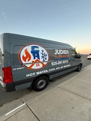 Branded service van parked on a street at sunset, with “JUDIEH” and hot water/cooling repair text.