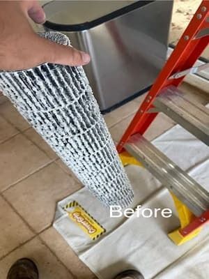 Hand holding a black-and-white textured strip beside a ladder and a floor pad labeled “Before”