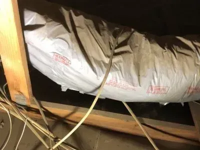 A large piece of plastic is hanging from the ceiling of a room.