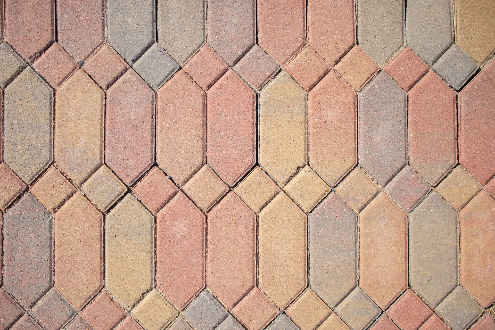 A close up of a brick walkway with a geometric pattern