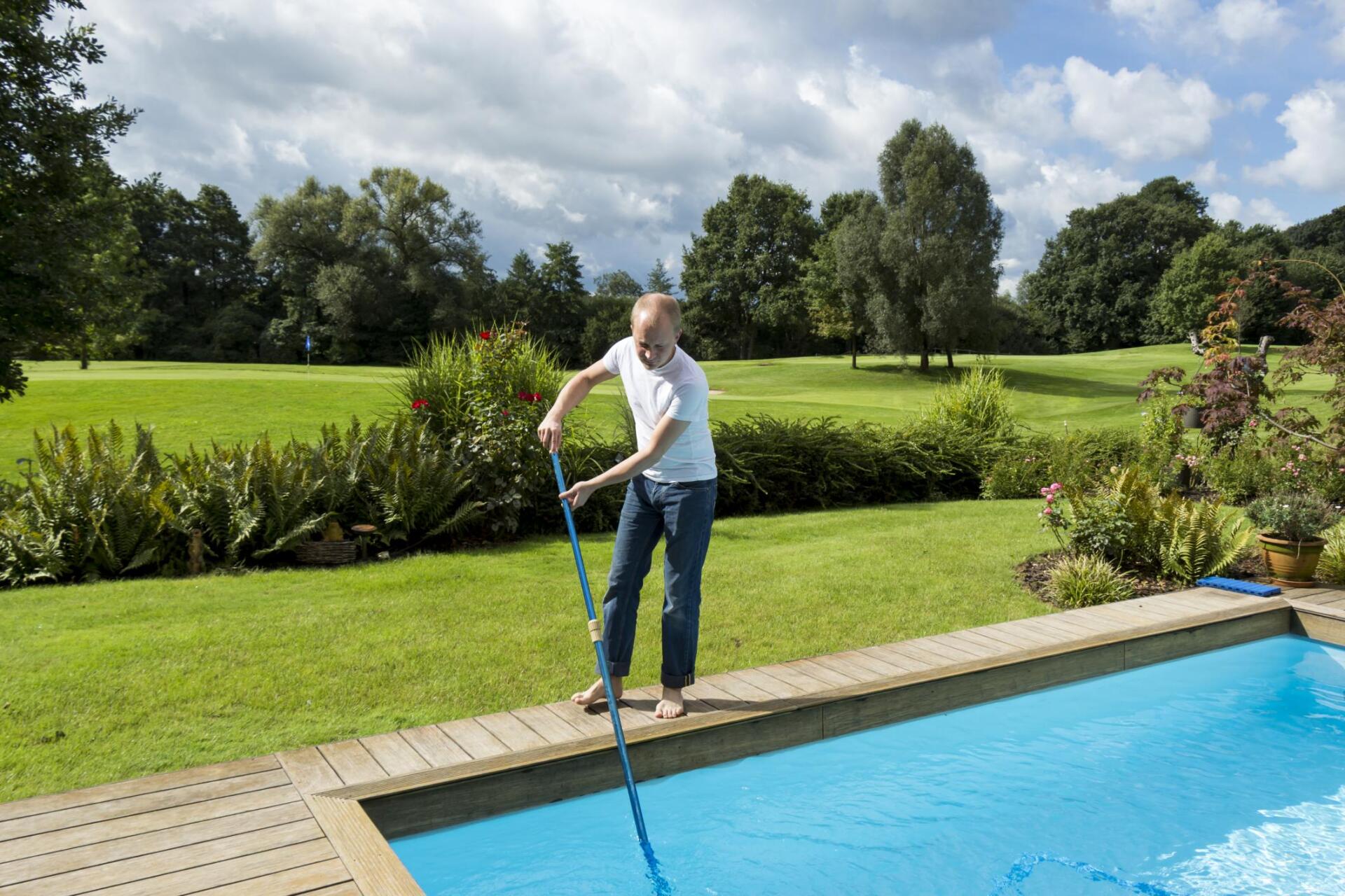 man standing beside the pool