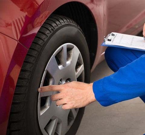 Volvo Maintenance — Mechanic Checking Car Tires in Walnut Creek, CA
