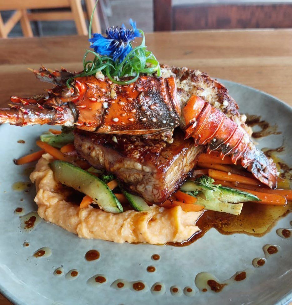 A plate of food with meat and vegetables on a table