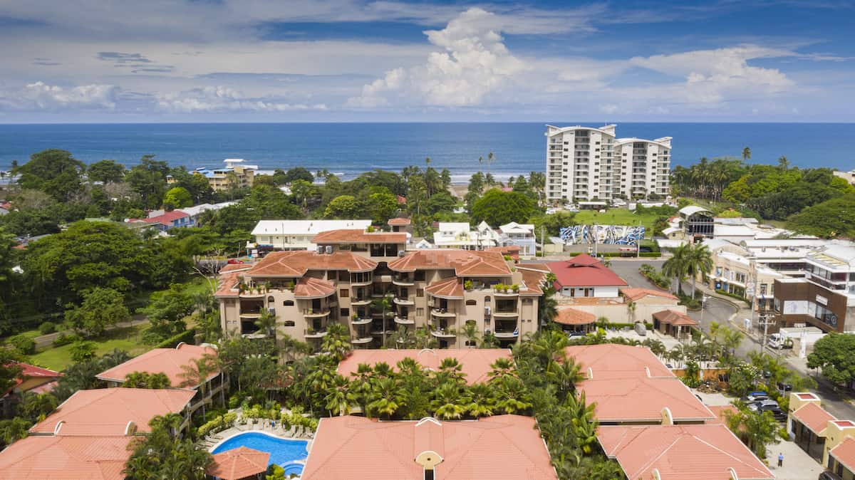 An aerial view of a city with a pool in the middle of it