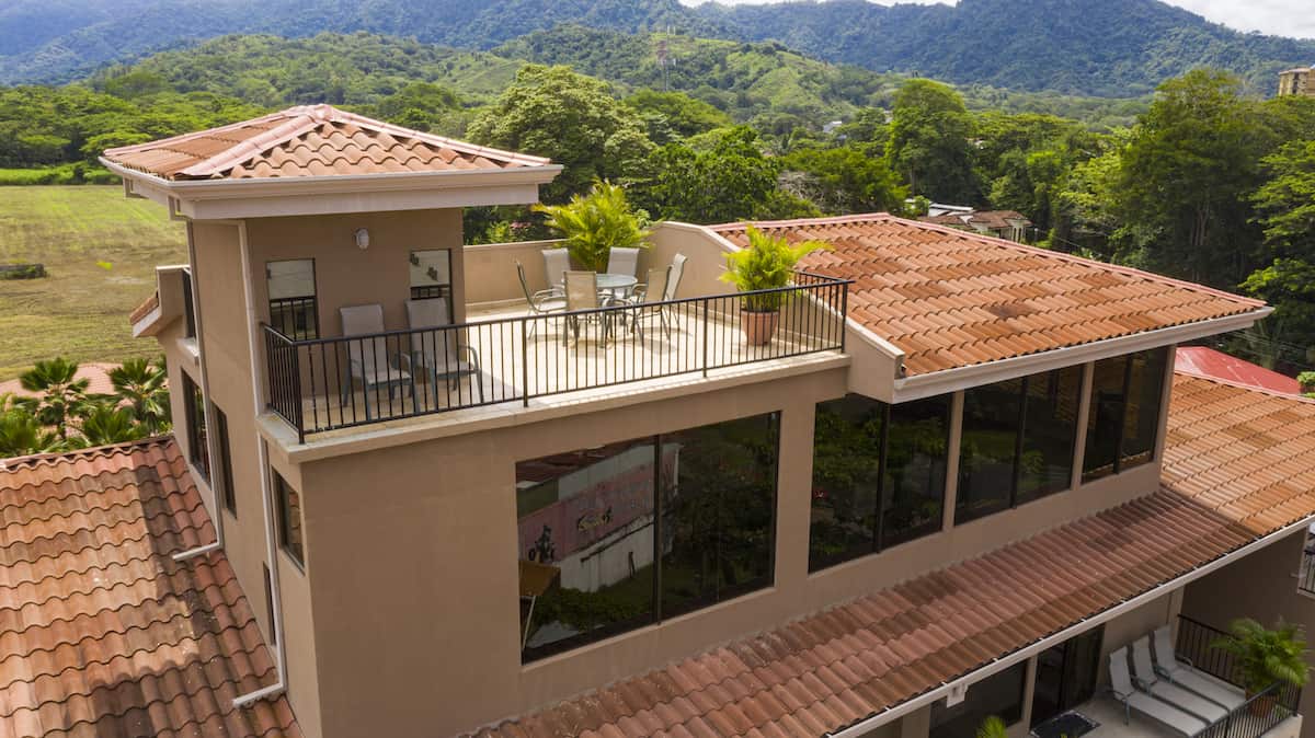 An aerial view of a house with a balcony on the roof