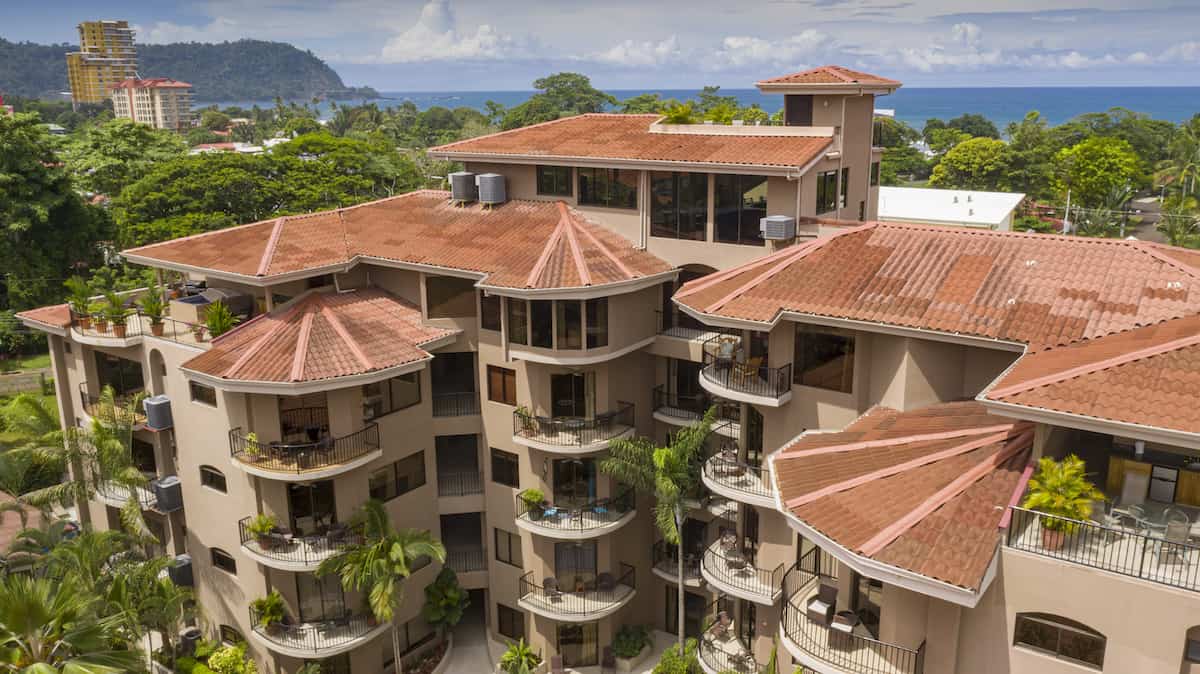 An aerial view of a large building with a red tiled roof