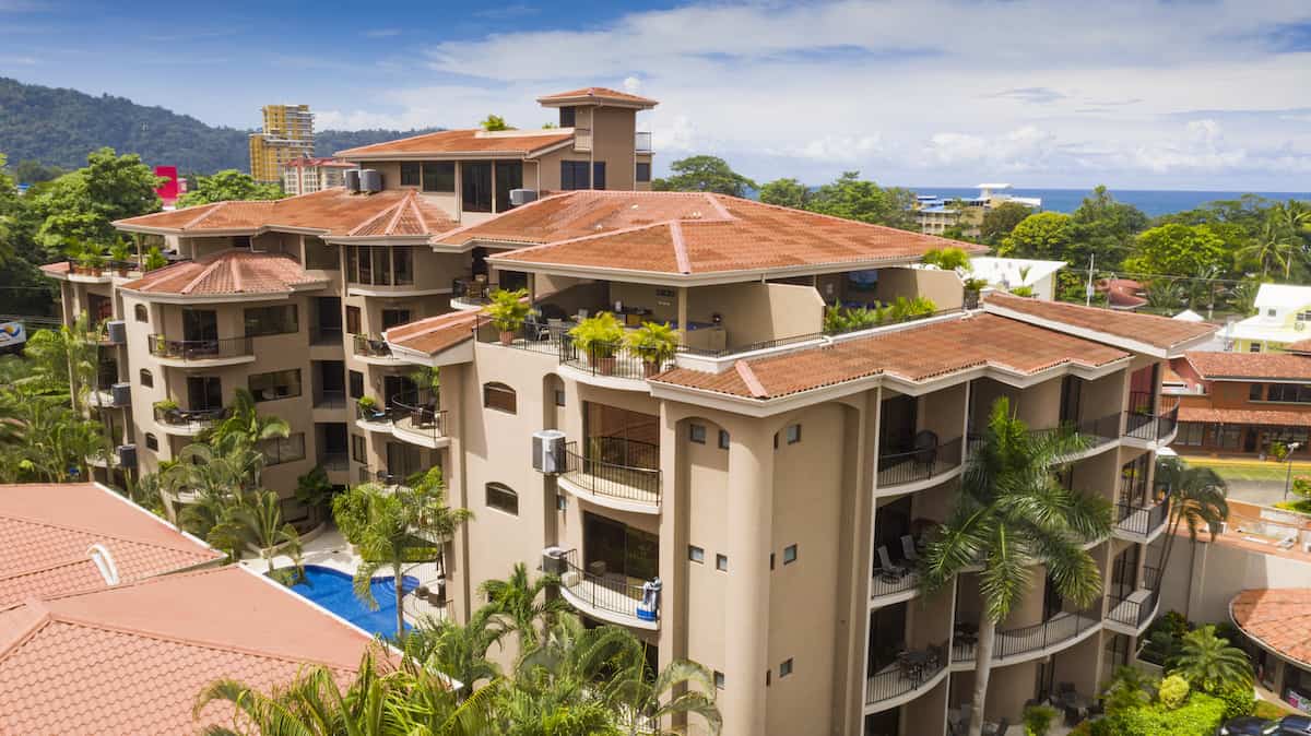 An aerial view of a large building with a red roof