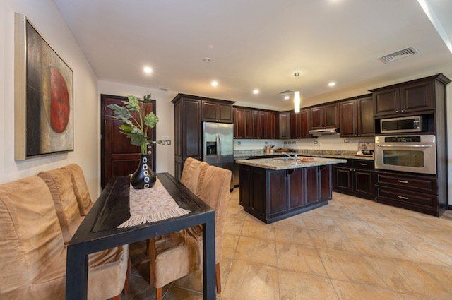 A kitchen with a table and chairs in it