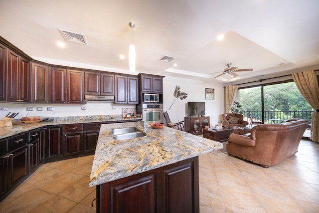 A kitchen with granite counter tops and wooden cabinets