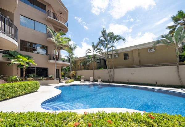 A large swimming pool in front of a building