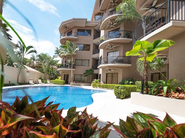 A large building with a swimming pool in front of it