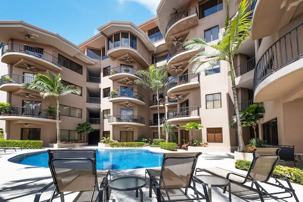A large building with a swimming pool in front of it