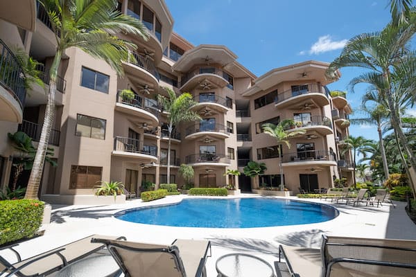 A large building with a swimming pool in front of it