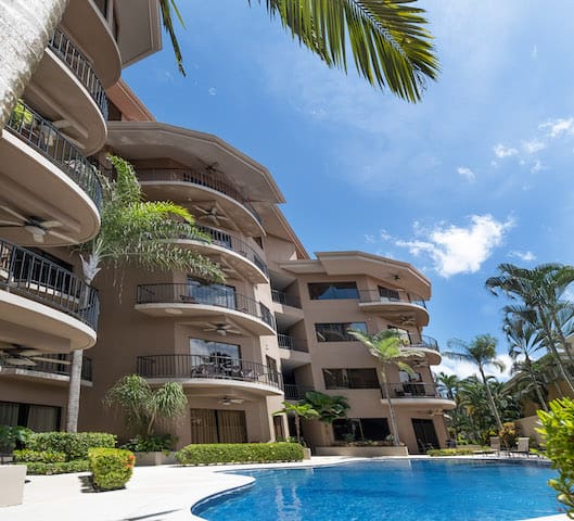 A large building with a swimming pool in front of it