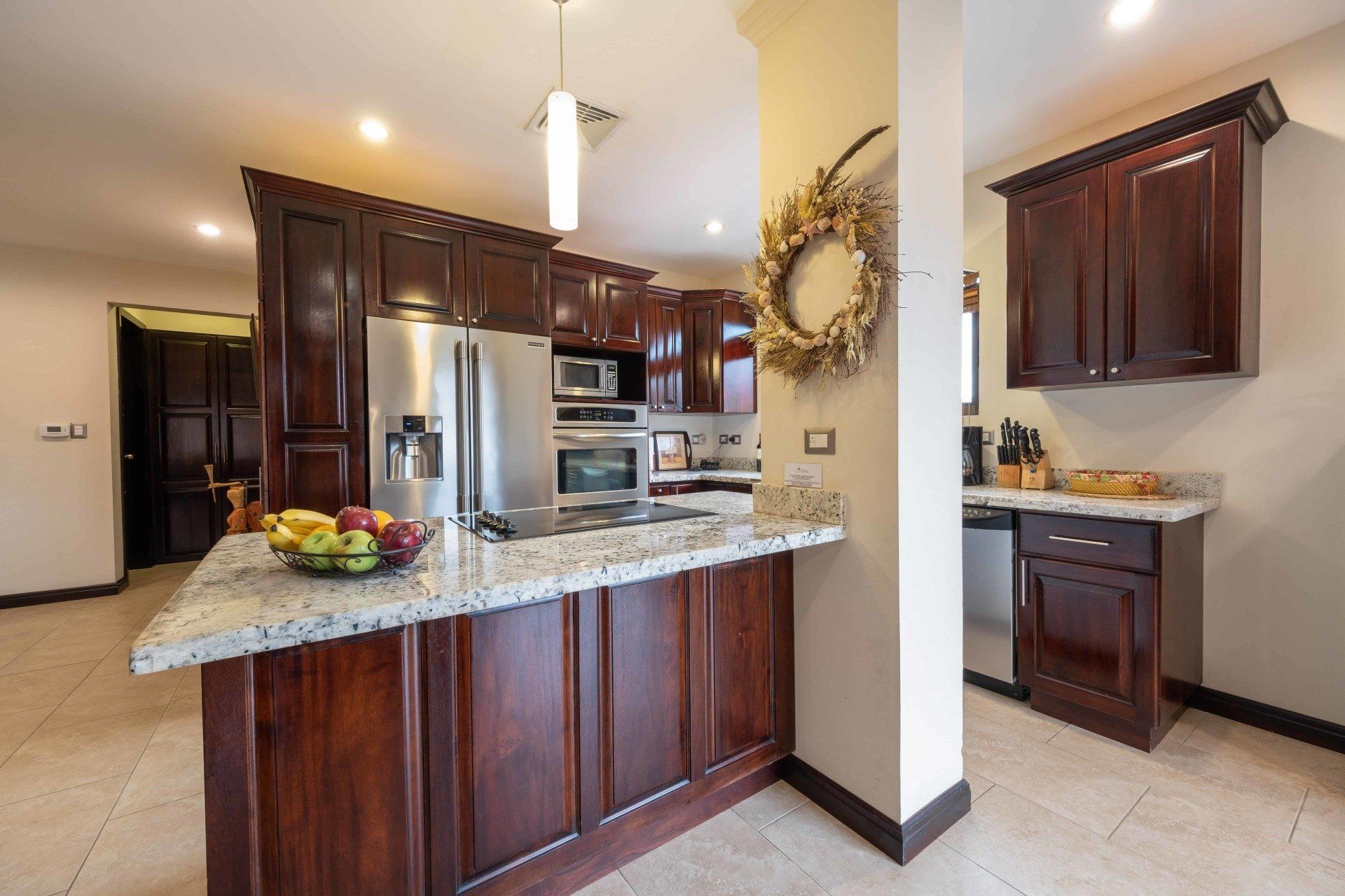 A kitchen with wooden cabinets and granite counter tops