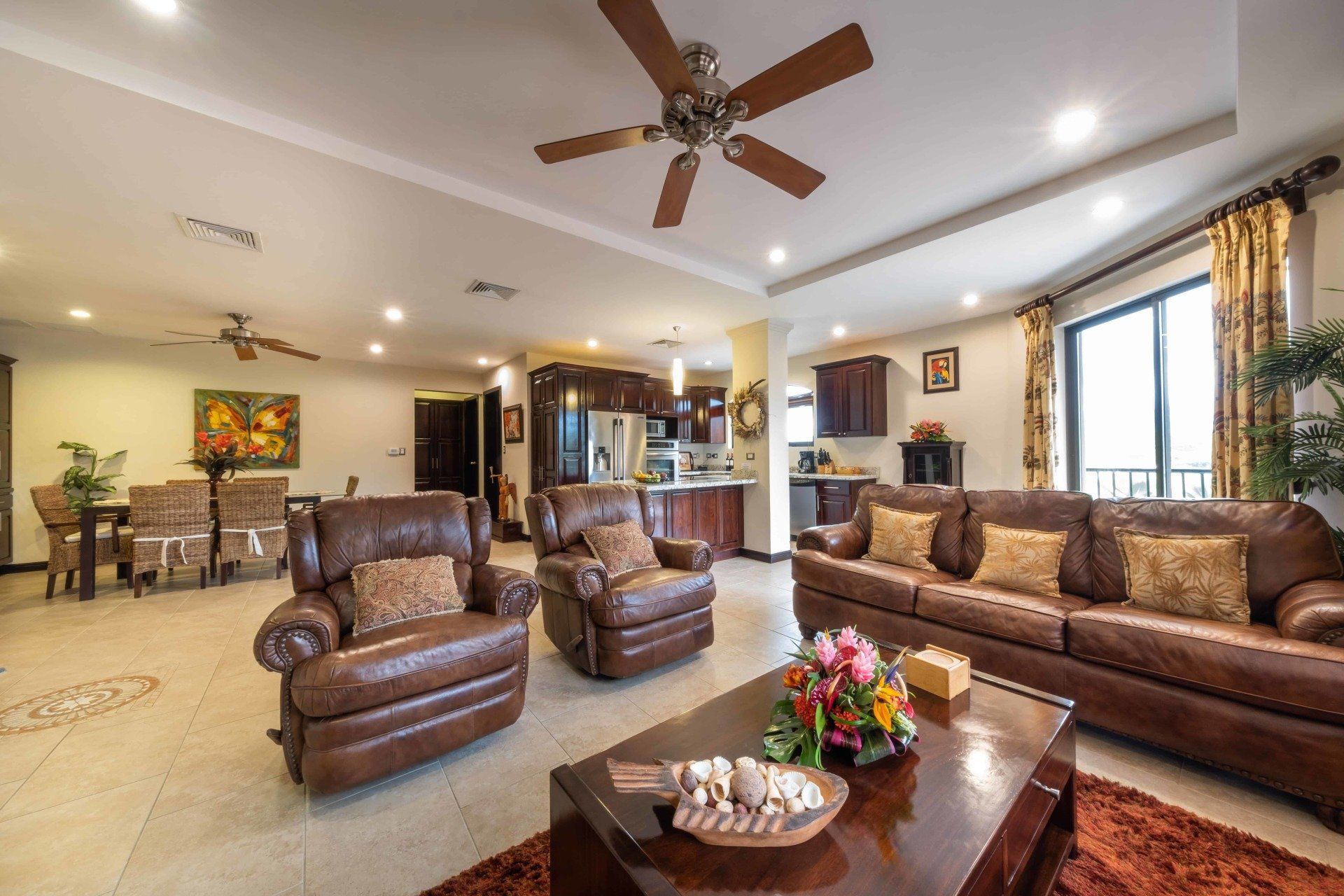 A living room filled with furniture and a ceiling fan.