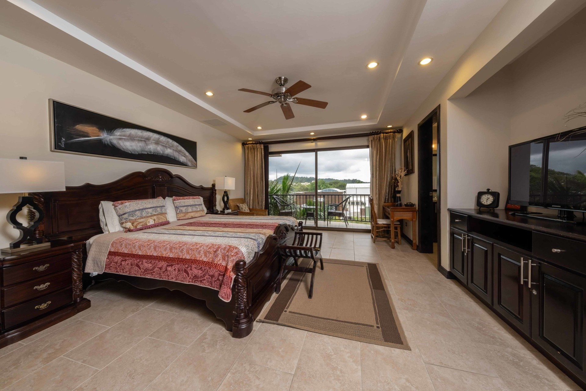 A bedroom with two beds and a ceiling fan