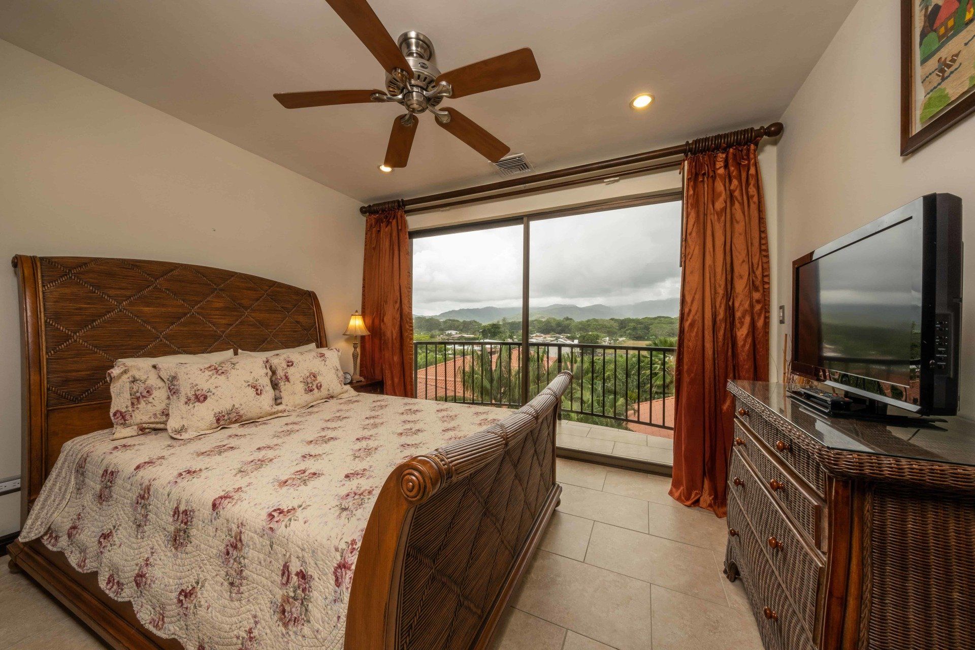 A bedroom with a king size bed and a flat screen tv