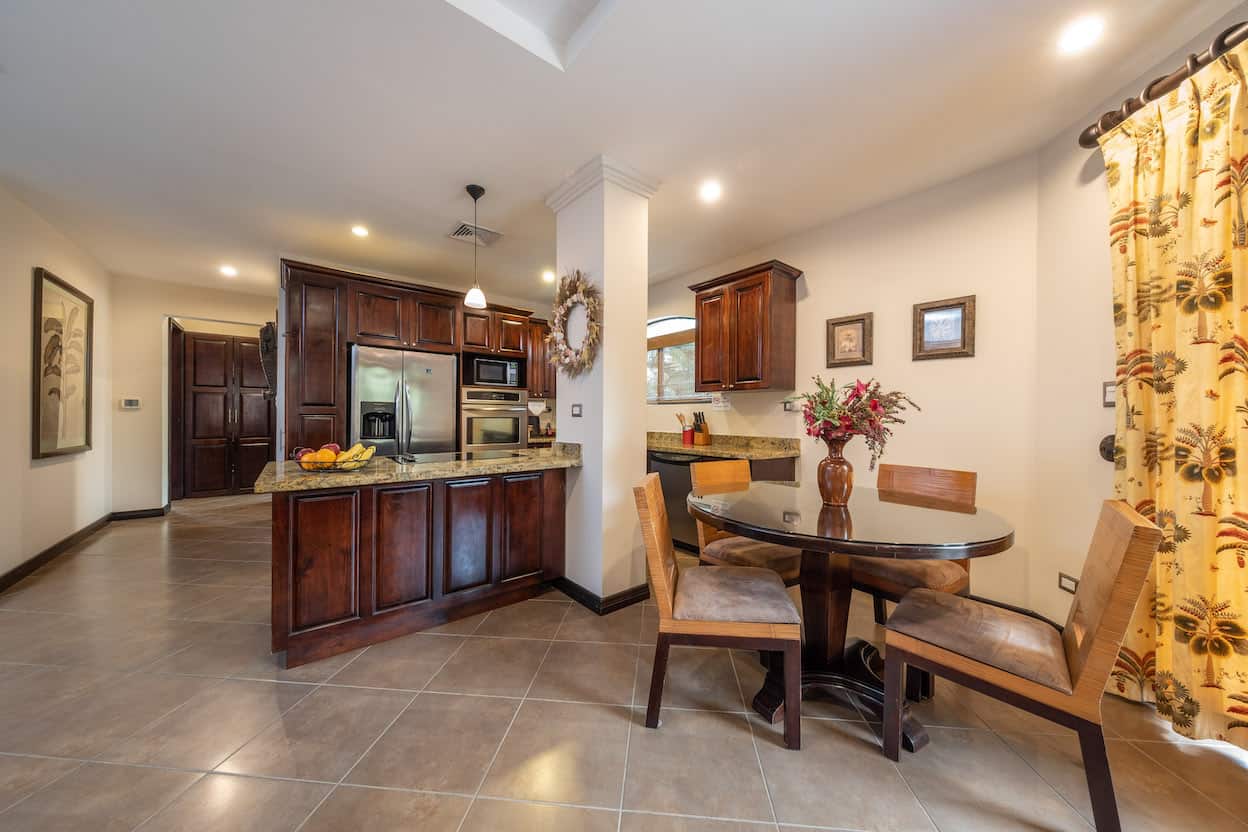 A kitchen with a table and chairs in it