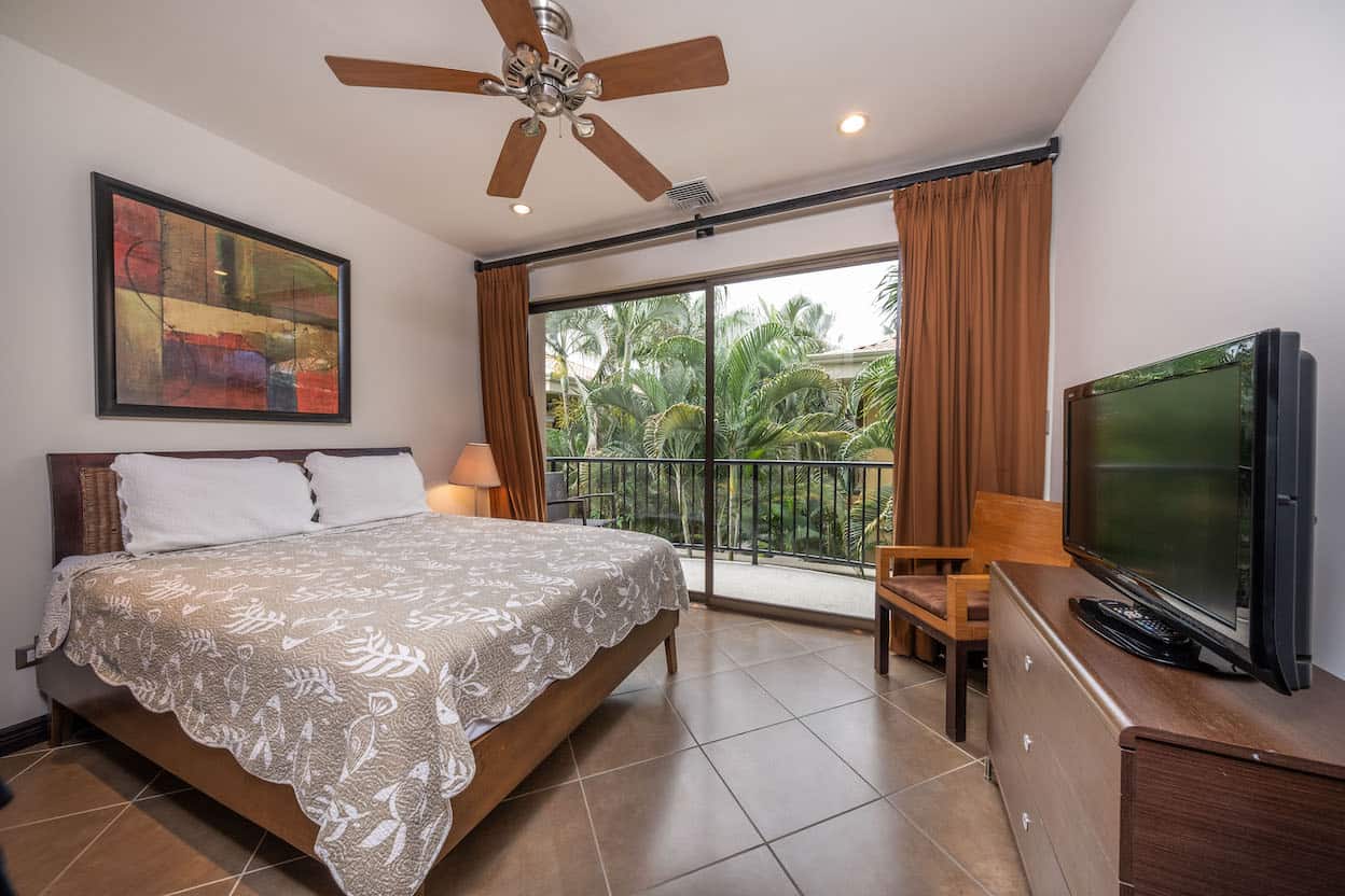 A bedroom with a king size bed and a flat screen tv