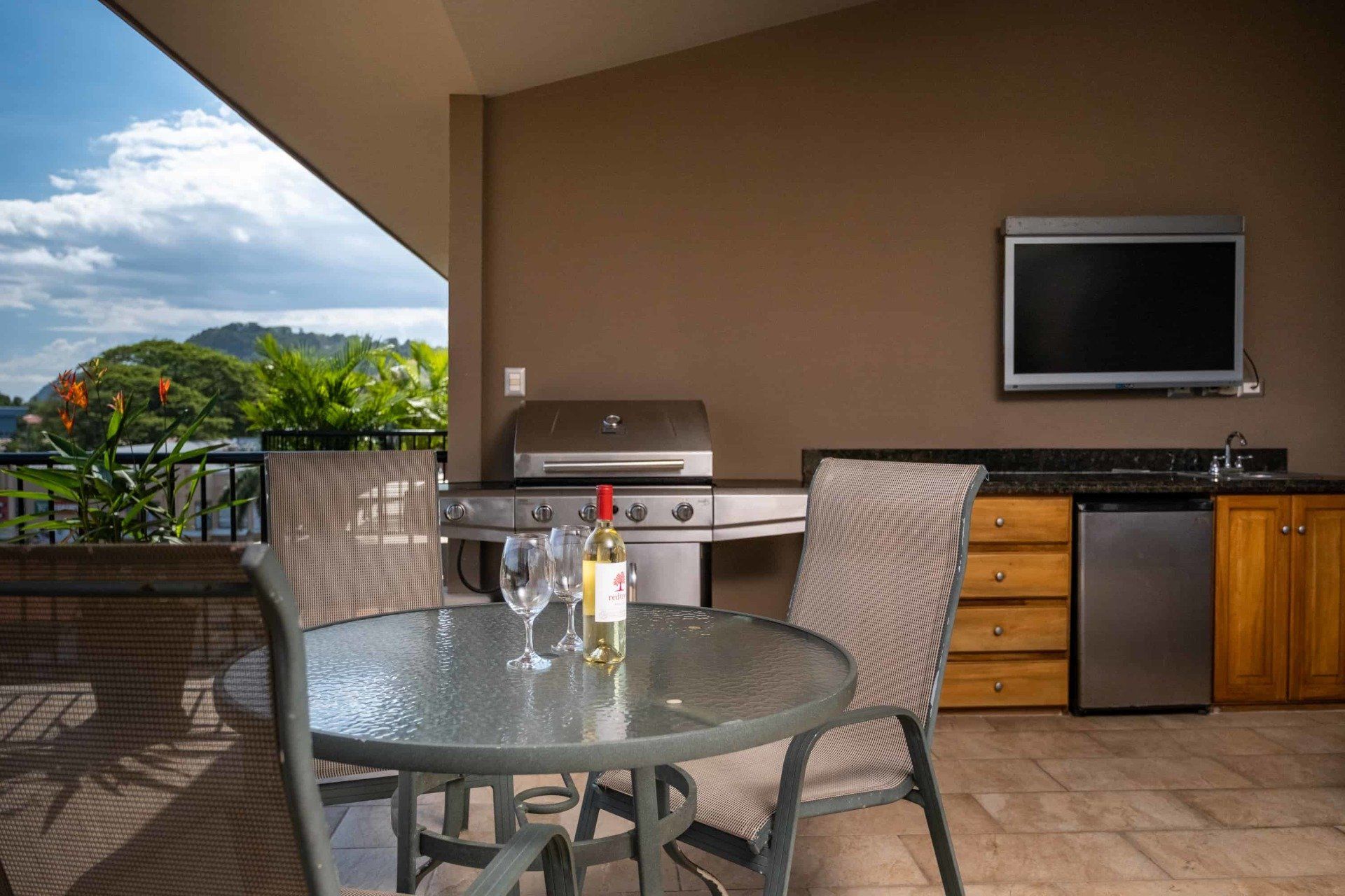 A table with a bottle of wine and two glasses on it