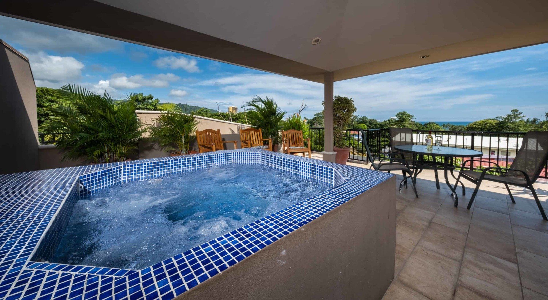 A jacuzzi on a balcony with a view of the ocean