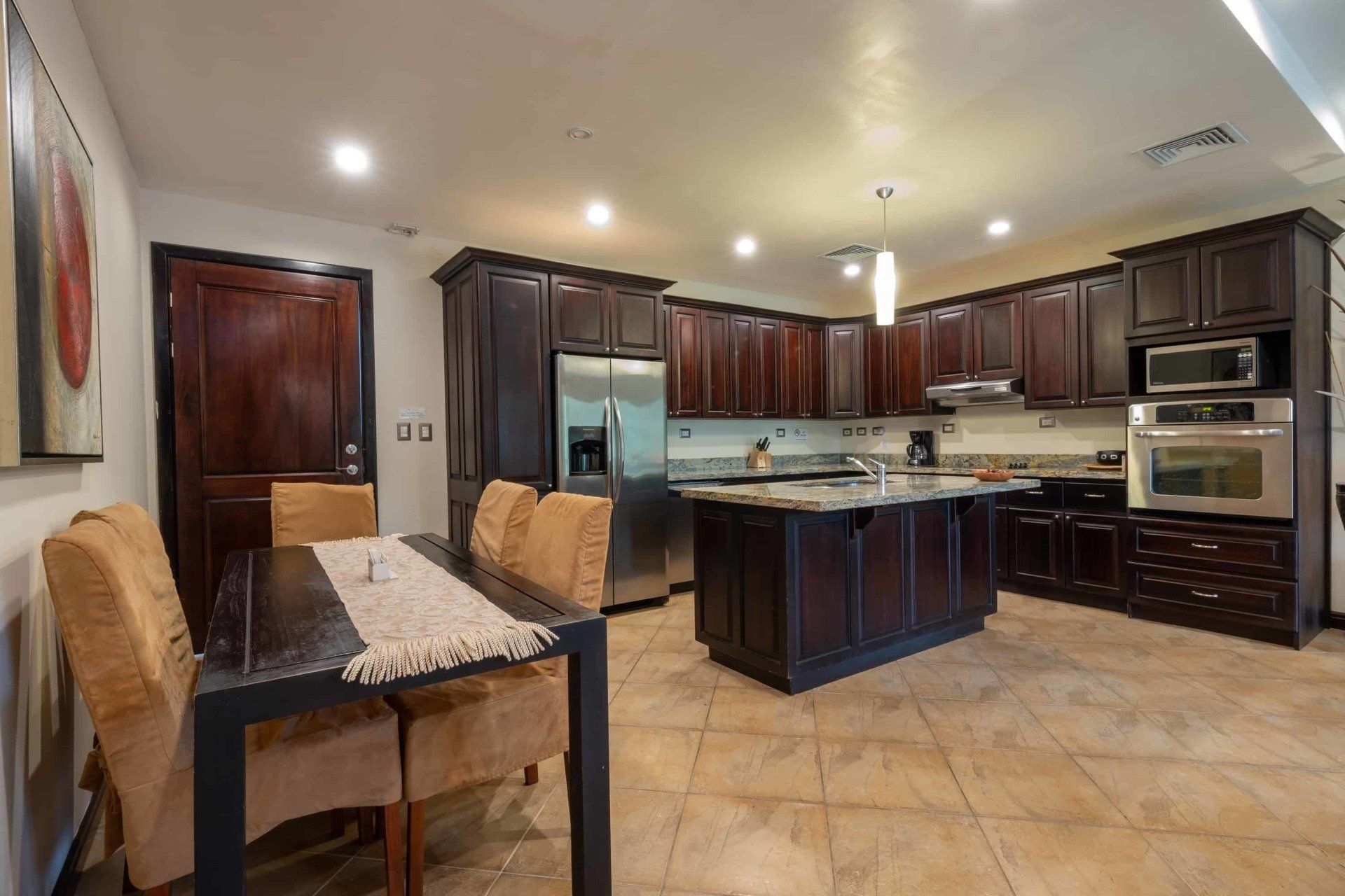 A kitchen with a table and chairs in it