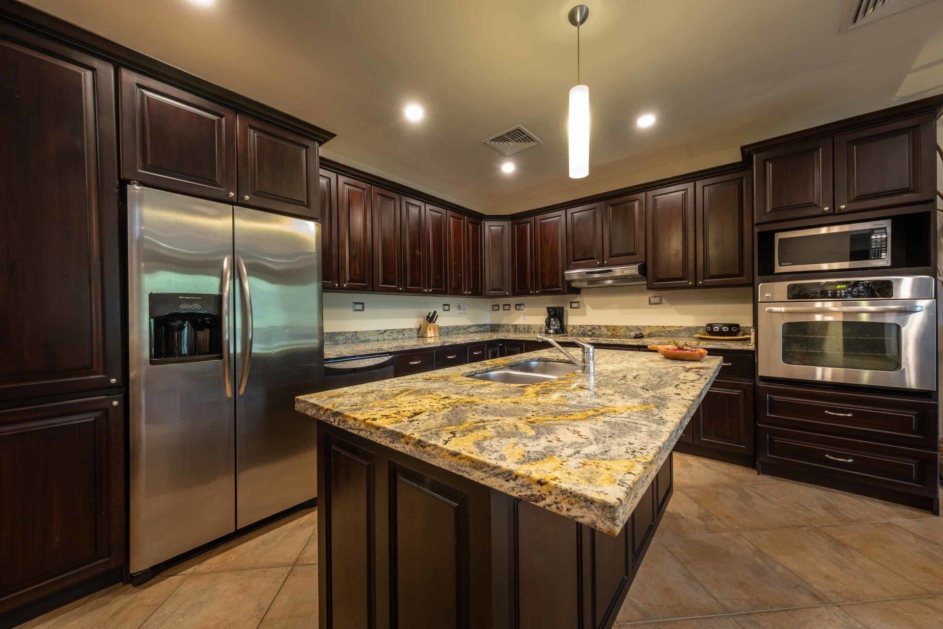 A kitchen with stainless steel appliances and granite counter tops