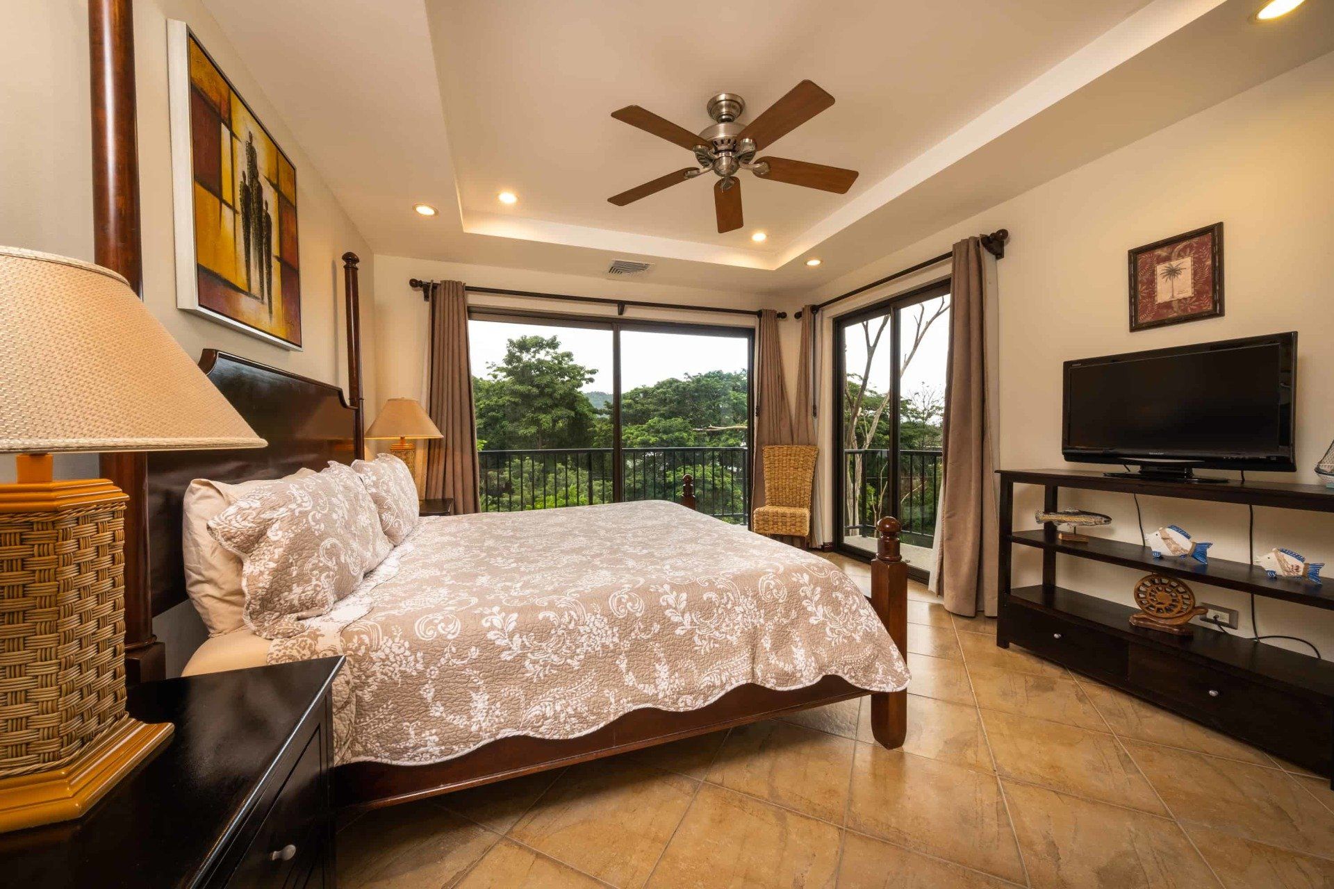 A bedroom with a king size bed and a flat screen tv