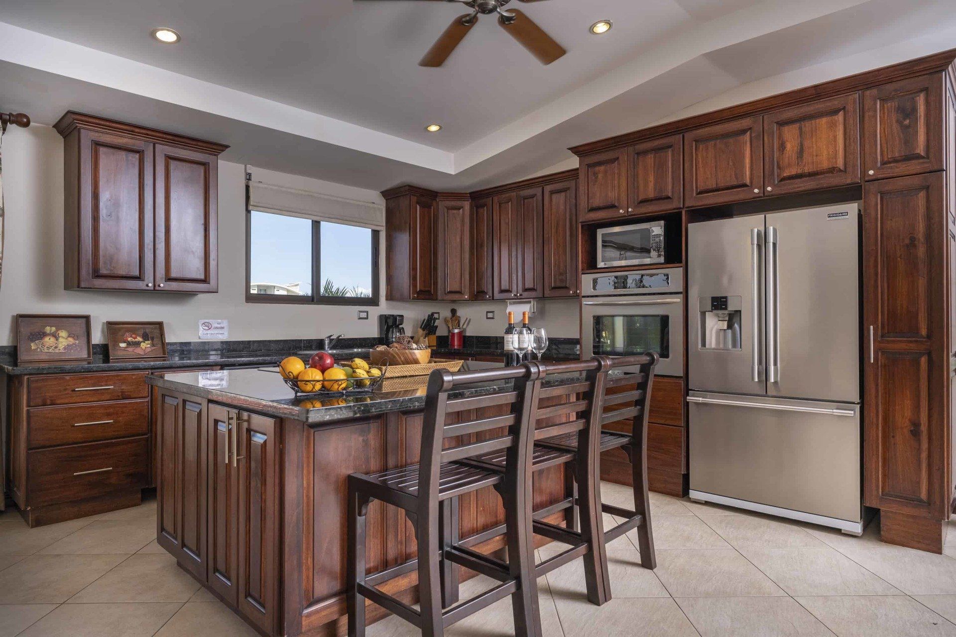 A kitchen with stainless steel appliances and wooden cabinets