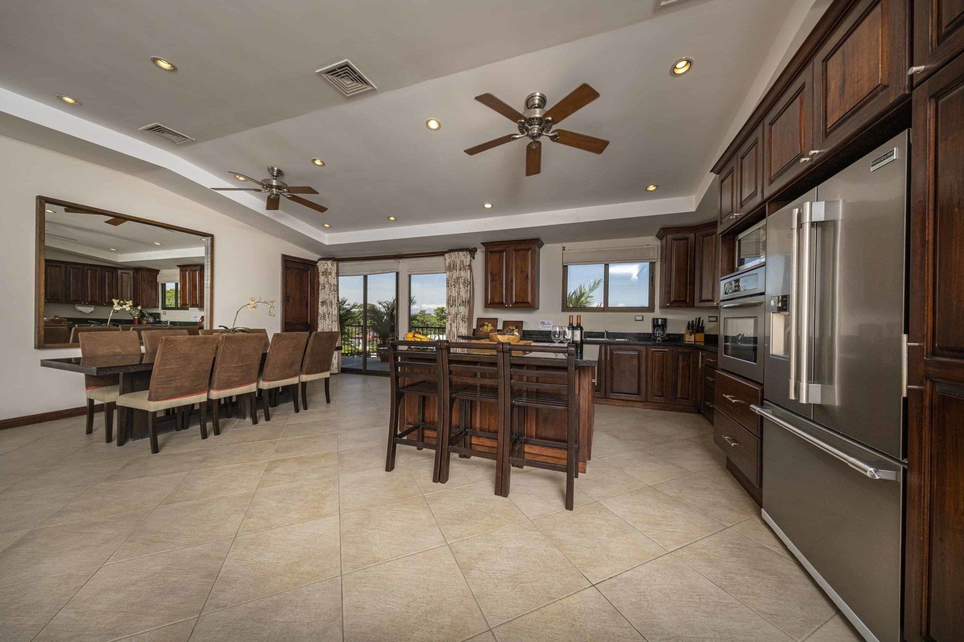 A large kitchen with stainless steel appliances and wooden cabinets