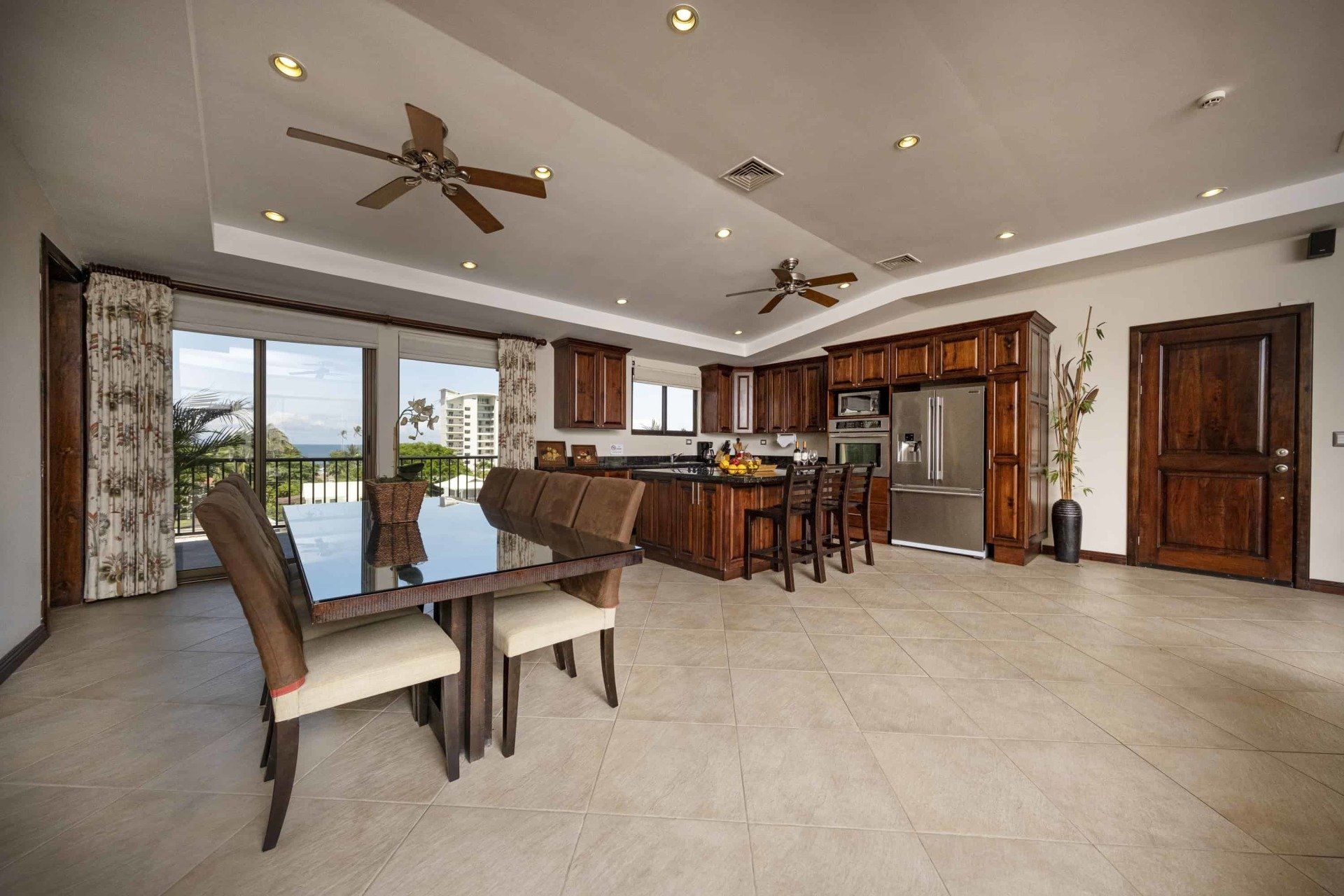A large room with a dining table and chairs and a kitchen