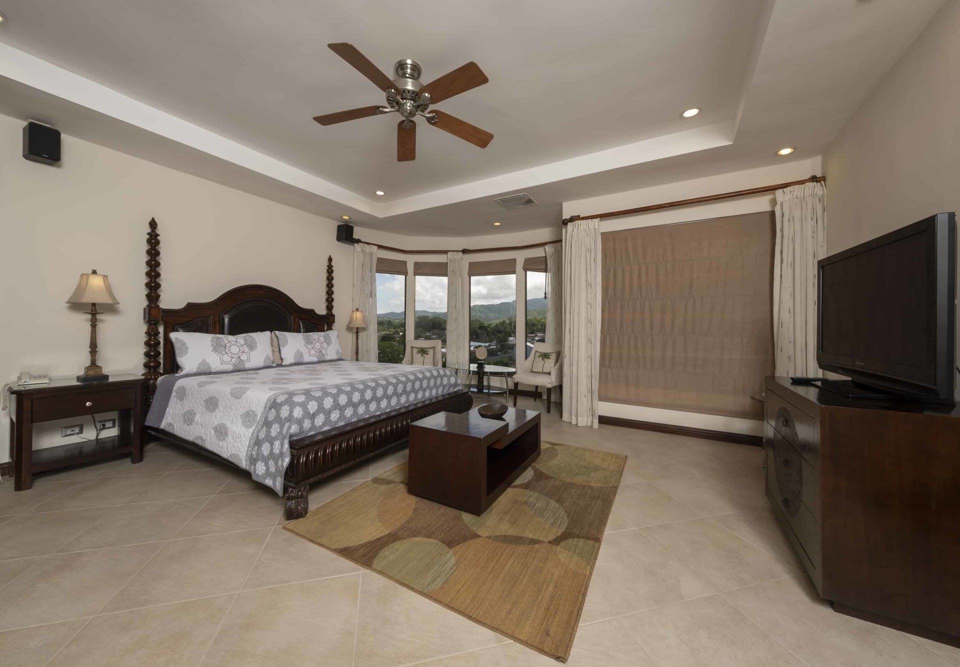 A bedroom with a king size bed and a flat screen tv