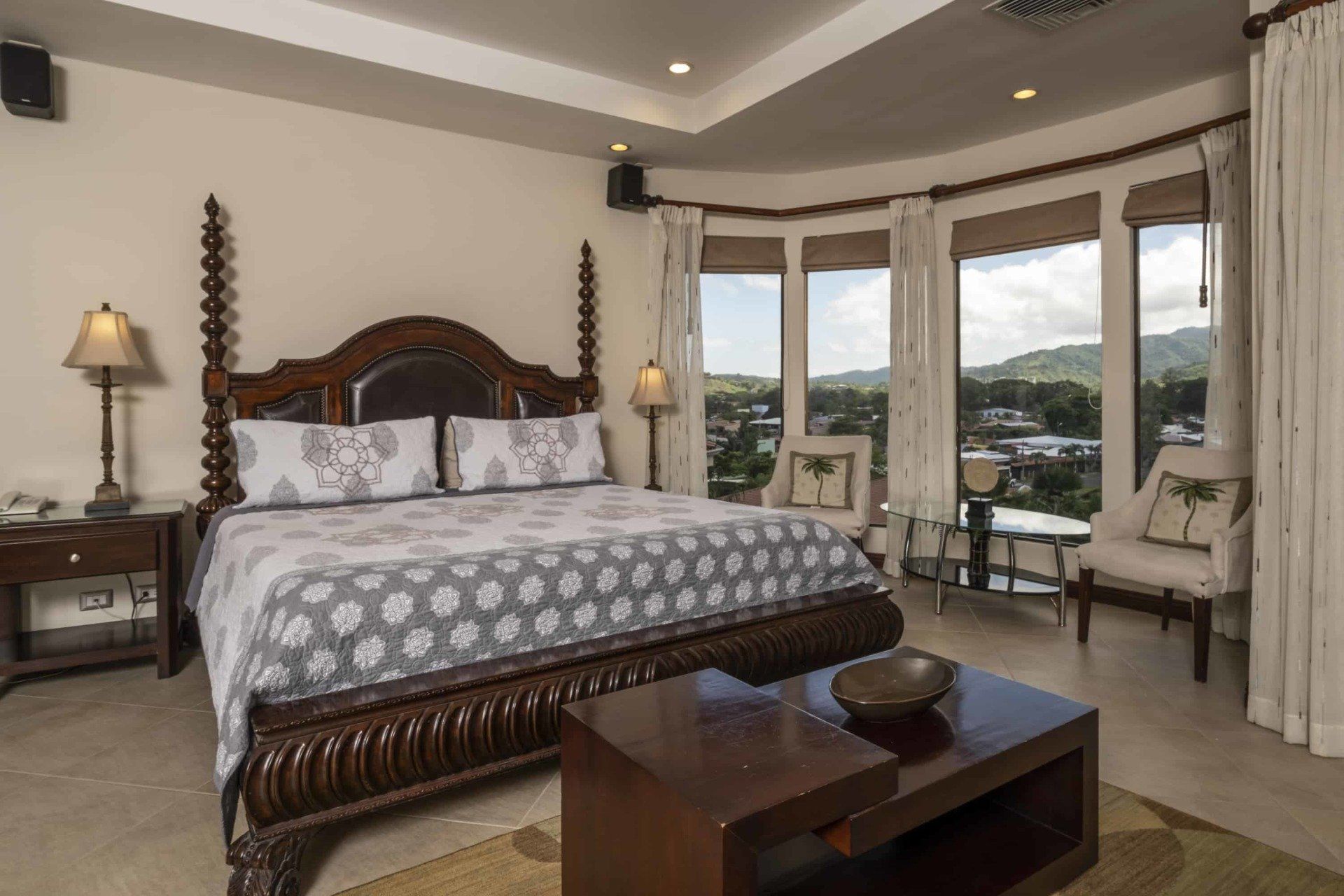 A bedroom with a king size bed and a coffee table