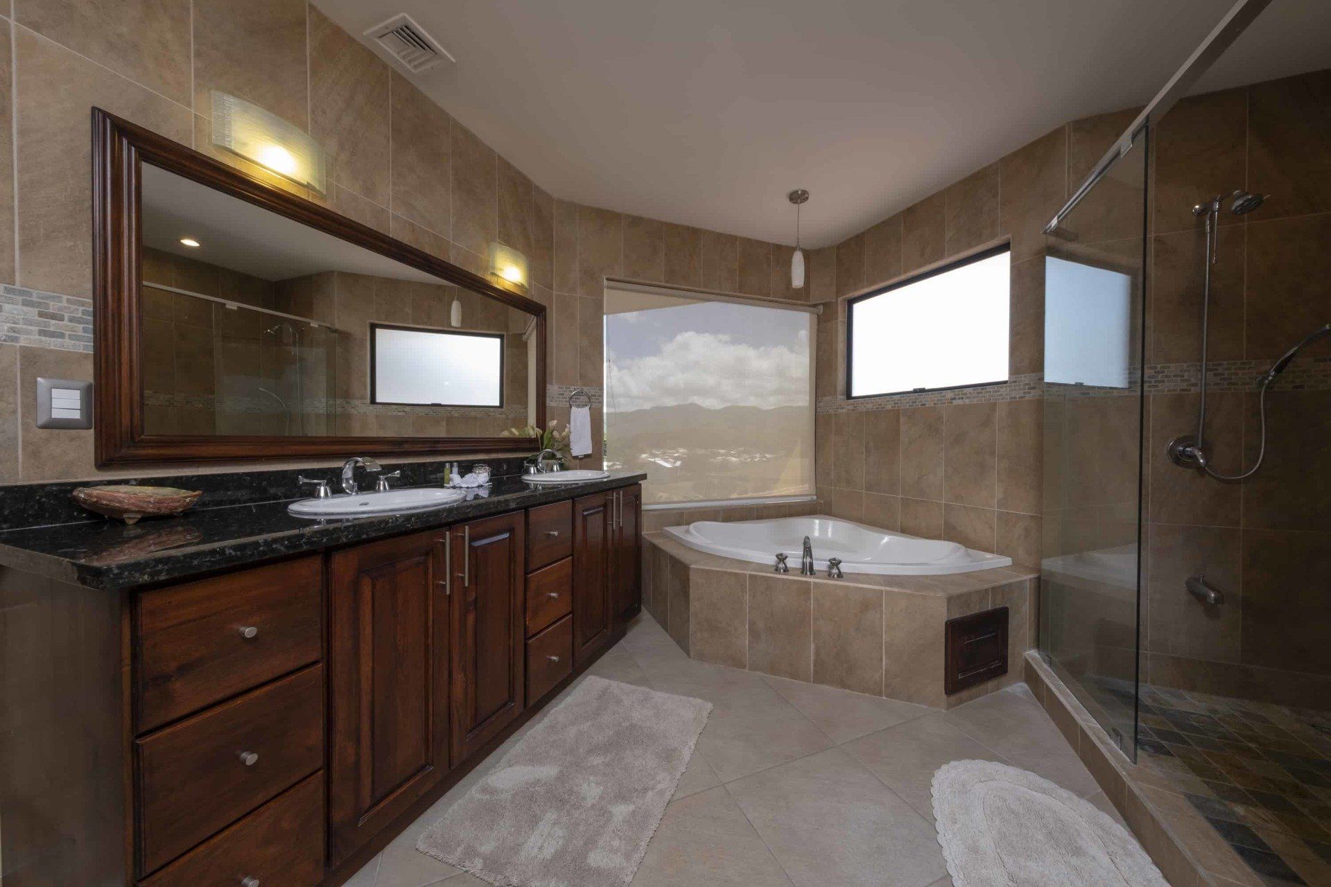 A bathroom with two sinks and a jacuzzi tub