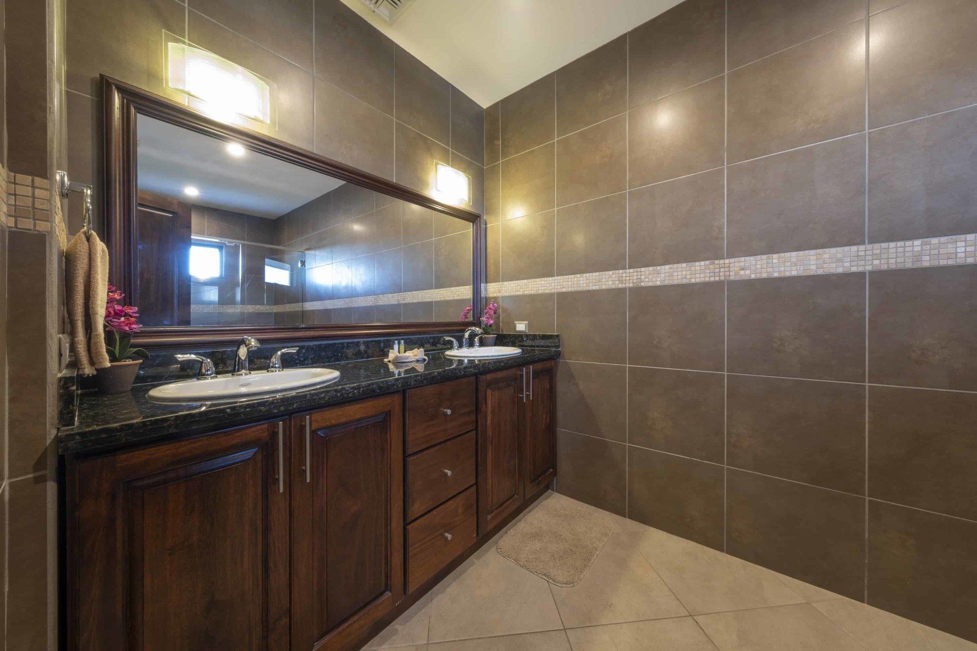 A bathroom with two sinks and a large mirror