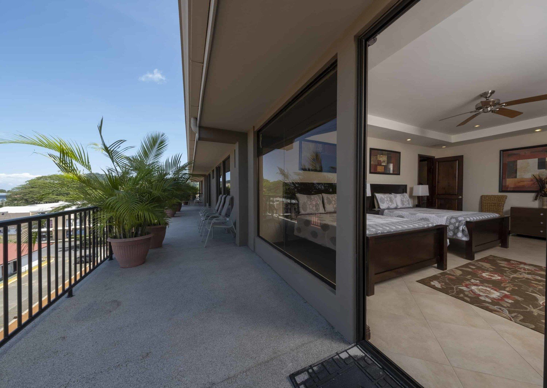 A balcony with a view of a bedroom with two beds