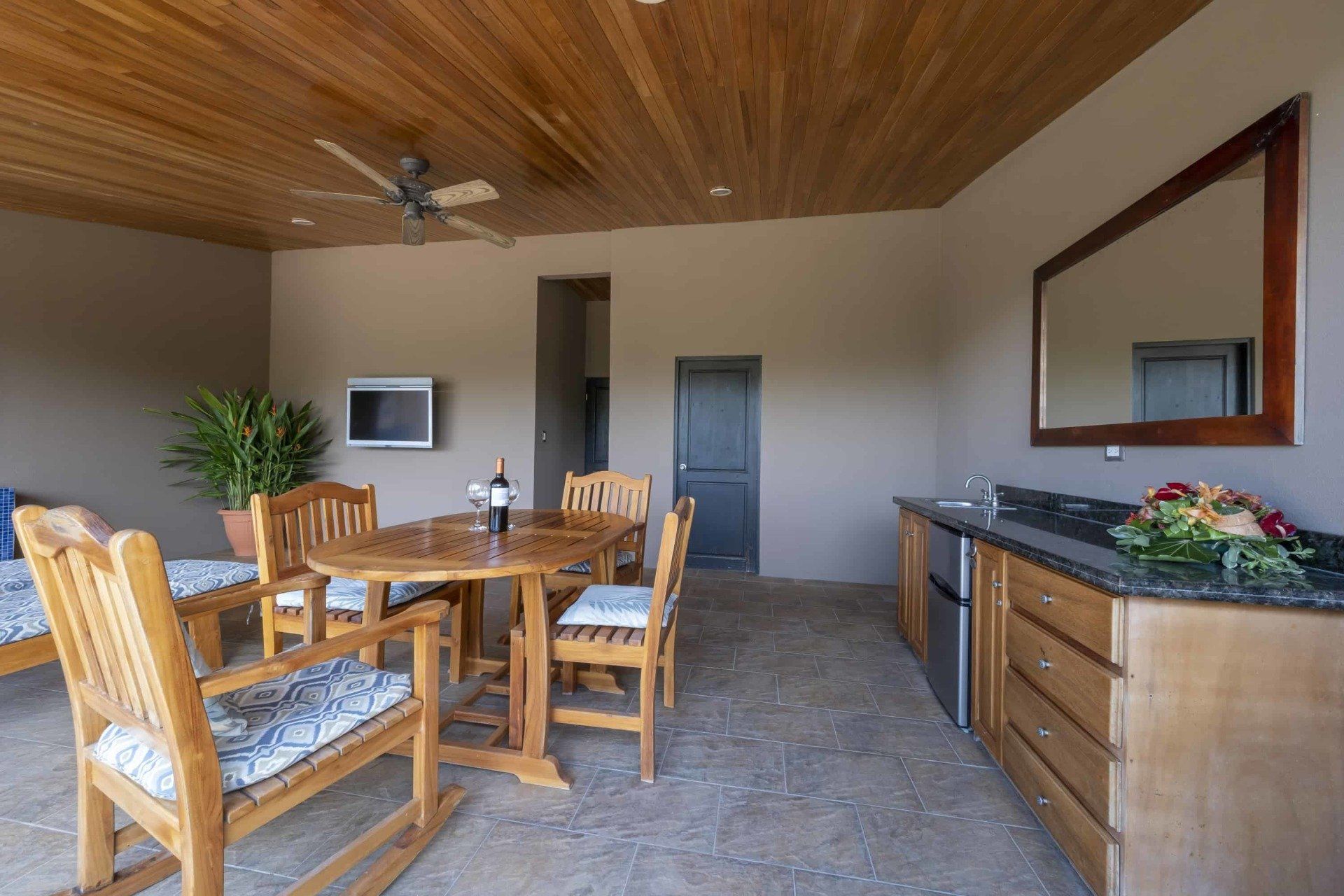 A living room with a table and chairs and a mirror