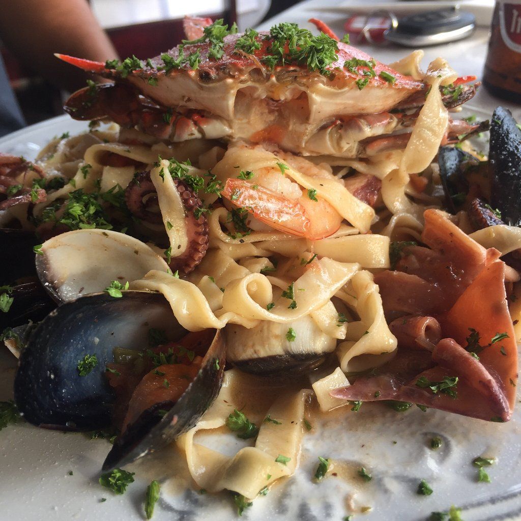 A close up of a plate of food with a coca cola can in the background
