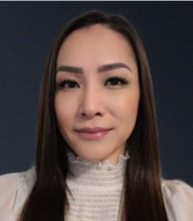 A woman with long hair is wearing a white shirt and smiling.
