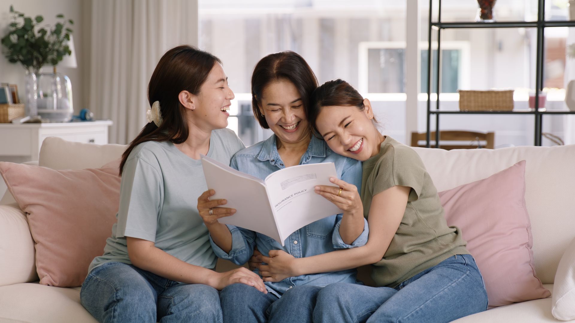Three woman smiling after insurance claim